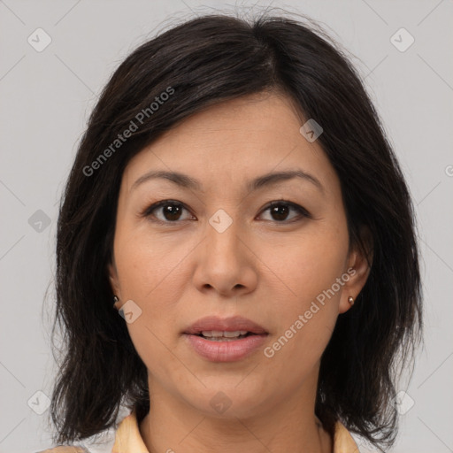 Joyful asian adult female with medium  brown hair and brown eyes