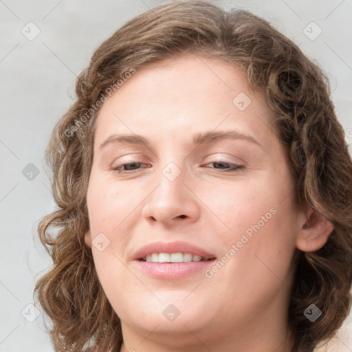 Joyful white young-adult female with medium  brown hair and blue eyes