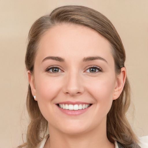 Joyful white young-adult female with medium  brown hair and grey eyes