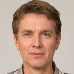 Joyful white adult male with short  brown hair and grey eyes