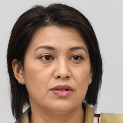 Joyful asian adult female with medium  brown hair and brown eyes
