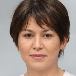 Joyful white adult female with medium  brown hair and brown eyes