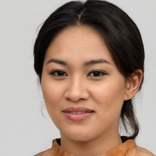 Joyful asian young-adult female with medium  brown hair and brown eyes