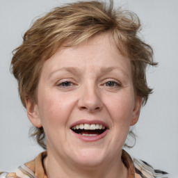 Joyful white adult female with medium  brown hair and blue eyes