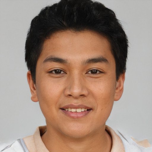 Joyful asian young-adult male with short  black hair and brown eyes