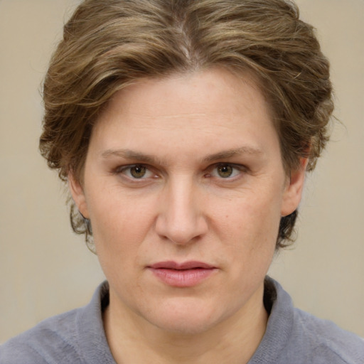 Joyful white adult female with medium  brown hair and blue eyes