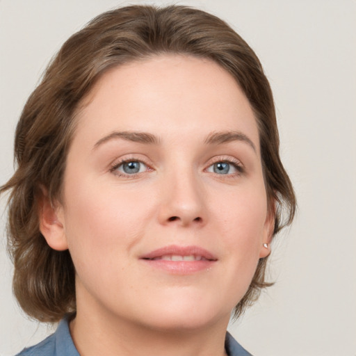 Joyful white young-adult female with medium  brown hair and blue eyes