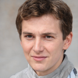 Joyful white adult male with short  brown hair and grey eyes