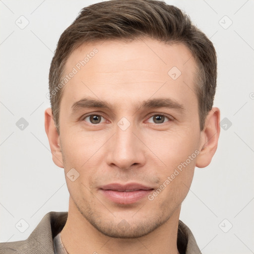 Joyful white young-adult male with short  brown hair and grey eyes