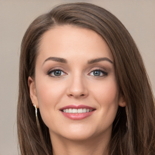 Joyful white young-adult female with long  brown hair and grey eyes