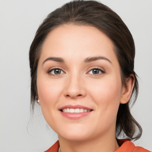 Joyful white young-adult female with medium  brown hair and brown eyes