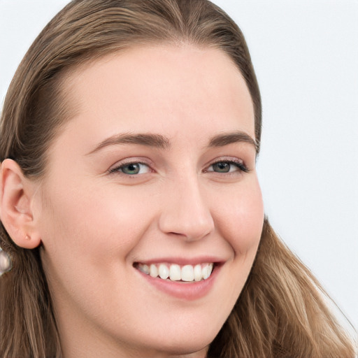 Joyful white young-adult female with long  brown hair and blue eyes