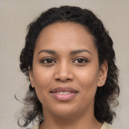 Joyful latino young-adult female with medium  brown hair and brown eyes