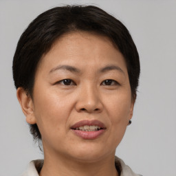 Joyful asian adult female with short  brown hair and brown eyes