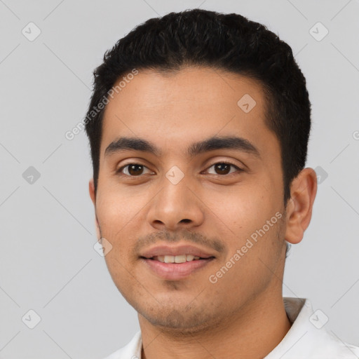 Joyful latino young-adult male with short  black hair and brown eyes