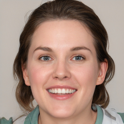 Joyful white young-adult female with medium  brown hair and blue eyes