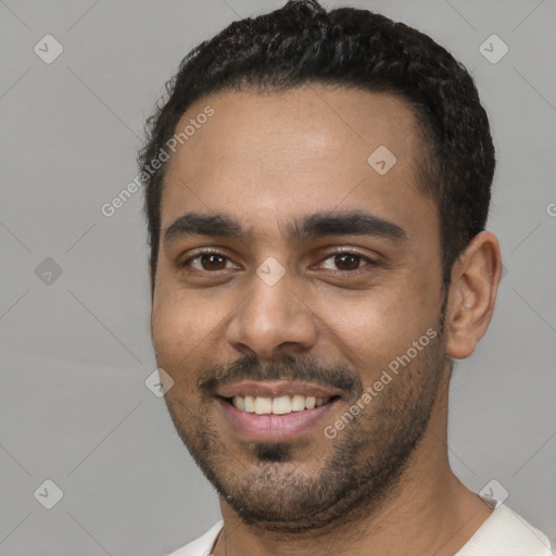 Joyful black young-adult male with short  black hair and brown eyes