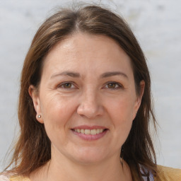 Joyful white adult female with medium  brown hair and brown eyes