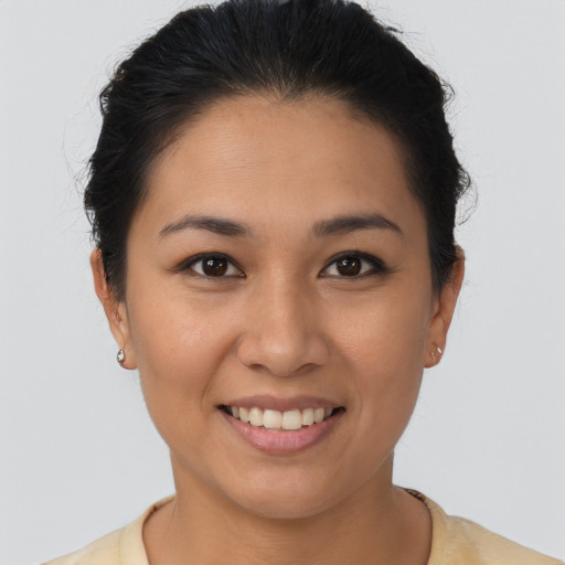 Joyful latino young-adult female with short  brown hair and brown eyes