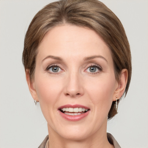 Joyful white adult female with medium  brown hair and grey eyes