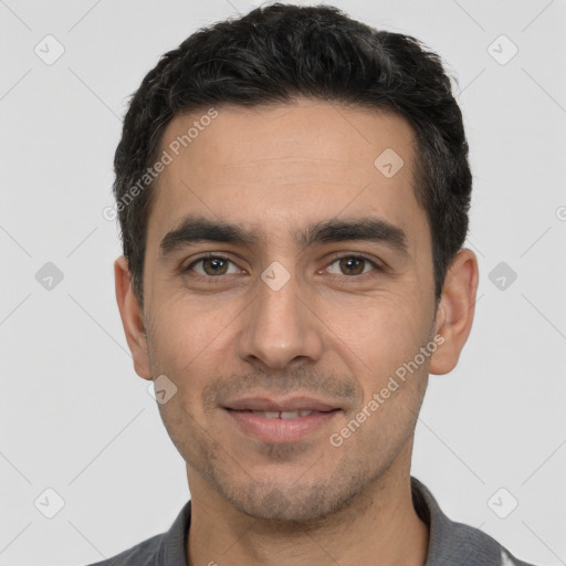 Joyful white young-adult male with short  black hair and brown eyes