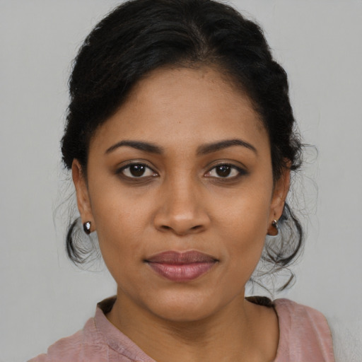 Joyful latino young-adult female with medium  brown hair and brown eyes