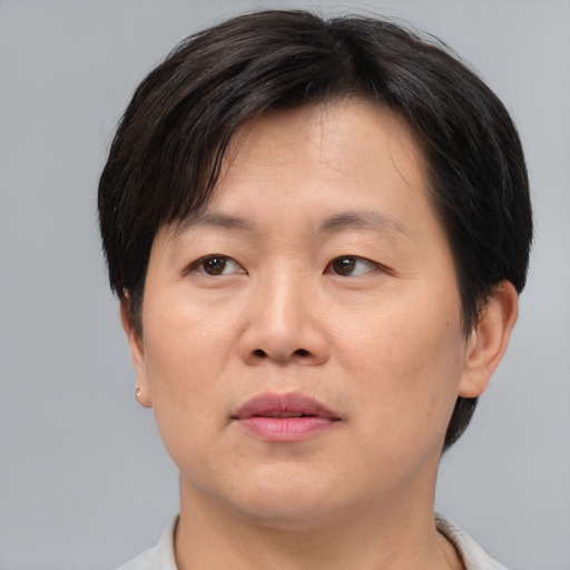 Joyful asian adult male with short  brown hair and brown eyes