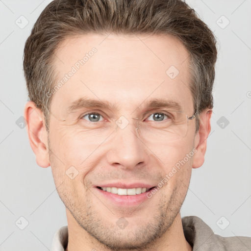 Joyful white adult male with short  brown hair and grey eyes