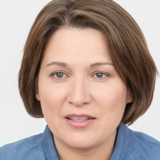 Joyful white adult female with medium  brown hair and grey eyes