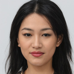 Joyful asian young-adult female with long  brown hair and brown eyes