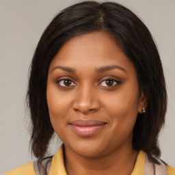 Joyful black young-adult female with medium  brown hair and brown eyes