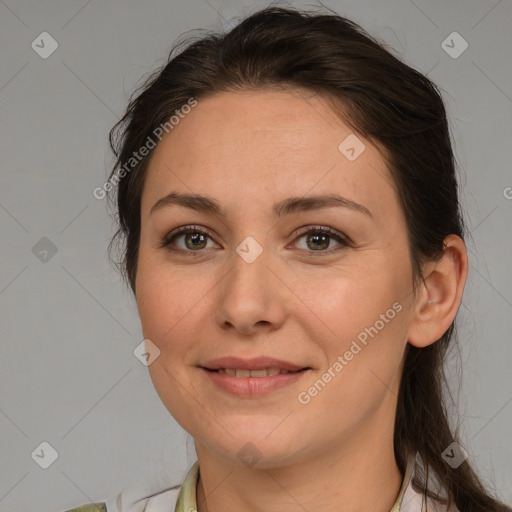 Joyful white adult female with medium  brown hair and brown eyes