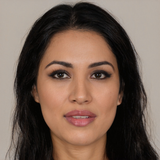 Joyful latino young-adult female with long  black hair and brown eyes