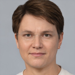 Joyful white adult male with short  brown hair and grey eyes