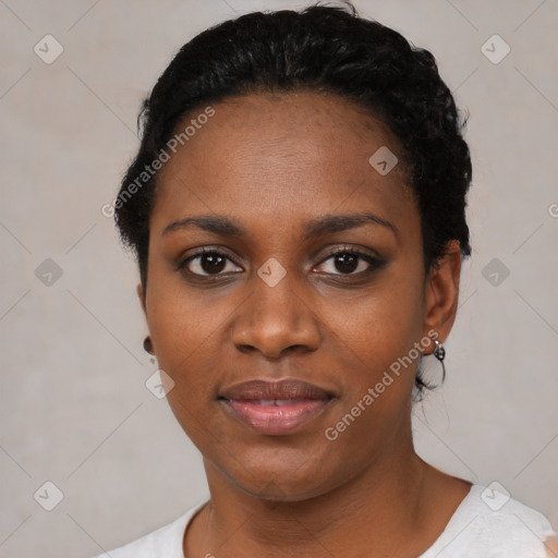 Joyful black young-adult female with short  black hair and brown eyes