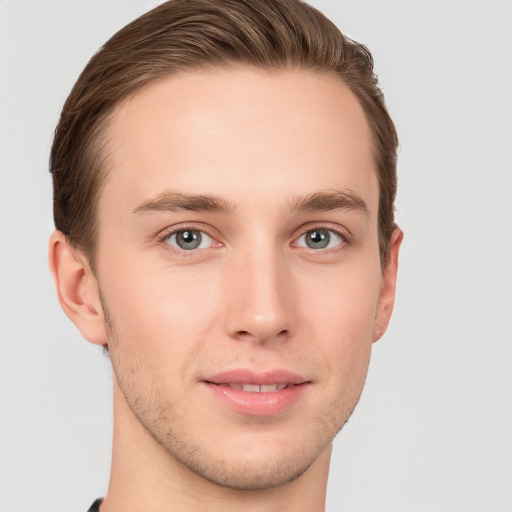 Joyful white young-adult male with short  brown hair and grey eyes