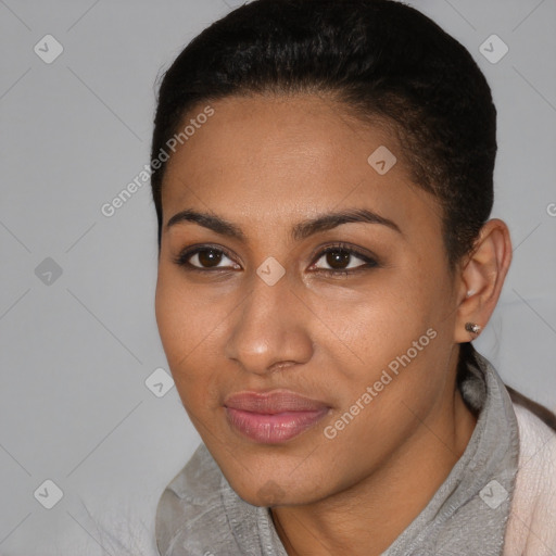 Joyful black young-adult female with short  brown hair and brown eyes