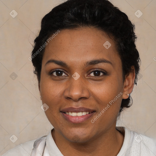 Joyful black young-adult female with short  black hair and brown eyes