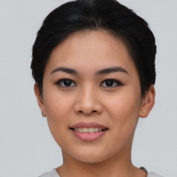 Joyful asian young-adult female with short  black hair and brown eyes