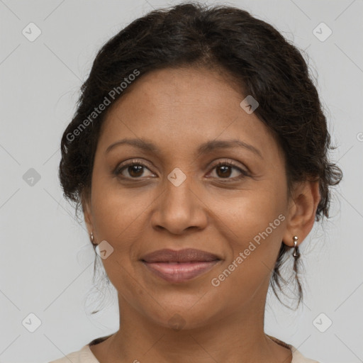 Joyful latino adult female with medium  brown hair and brown eyes