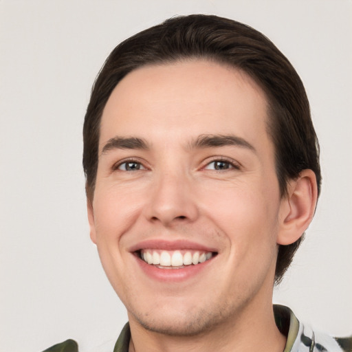 Joyful white young-adult male with short  brown hair and brown eyes