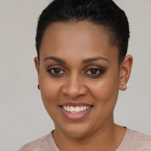 Joyful black young-adult female with short  brown hair and brown eyes
