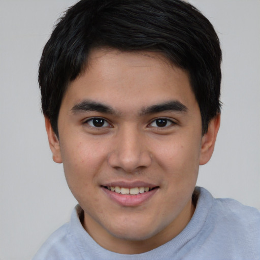 Joyful asian young-adult male with short  brown hair and brown eyes