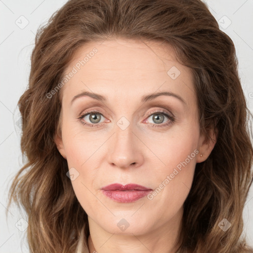 Joyful white adult female with long  brown hair and green eyes