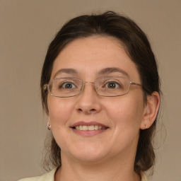 Joyful white adult female with medium  brown hair and brown eyes