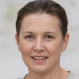 Joyful white adult female with short  brown hair and grey eyes