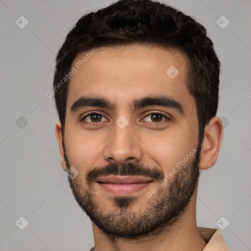 Joyful white young-adult male with short  black hair and brown eyes