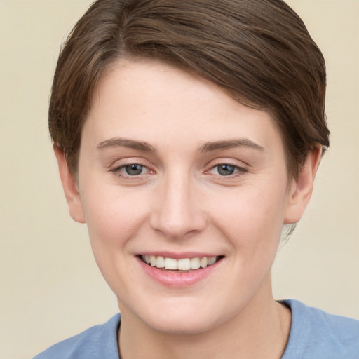 Joyful white young-adult female with short  brown hair and grey eyes