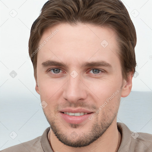 Joyful white young-adult male with short  brown hair and grey eyes