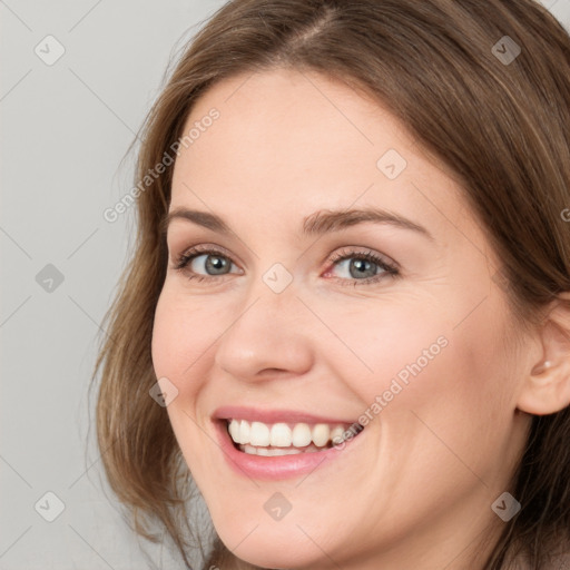 Joyful white young-adult female with long  brown hair and grey eyes